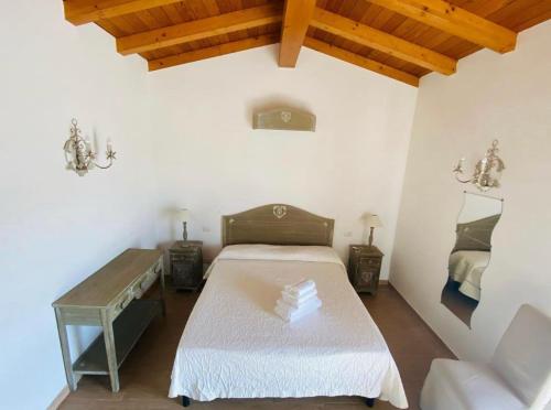 a bedroom with a bed and a table in a room at La Casa Rotta in San Felice Circeo