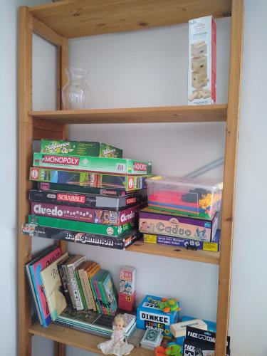 a book shelf filled with lots of books at Family Friendly Apt A, Garden, 900m LegoHouse, Lalandia, Legoland in Billund