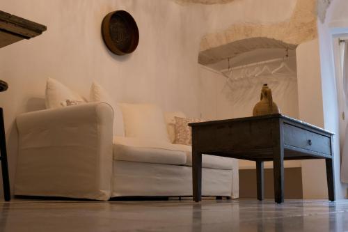 a living room with a couch and a table at Rosa Trulli suite in Alberobello