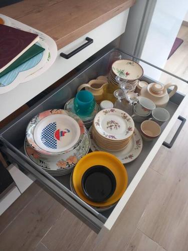 a drawer filled with plates and cups and dishes at Grand Studio provençal, piscine vue magnifique in Carnoules