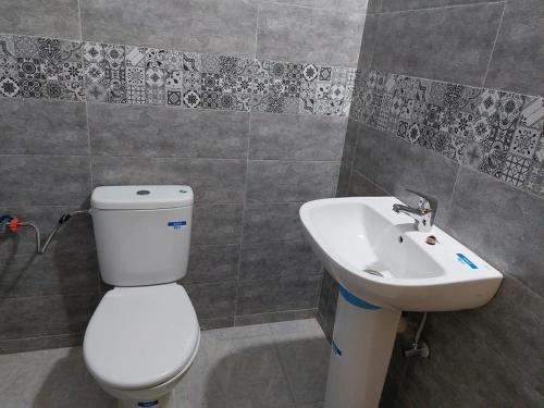 a bathroom with a toilet and a sink at RESIDANCE ESSALAM in Laayoune