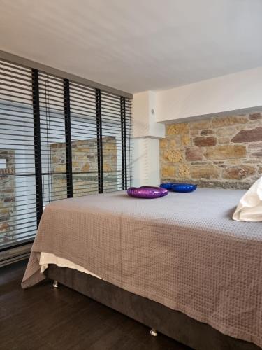 a bedroom with a large bed with two pillows on it at Castle luxury home in Chios