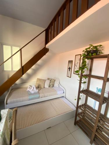 a small room with a bench under a staircase at Casa de Seu Bandeira in Maragogi