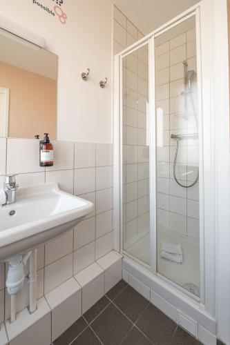 a bathroom with a sink and a shower at UCPA SPORT STATION HOSTEL PARIS in Paris