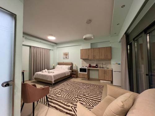 a living room with a bed and a kitchen at Nicolas Luxury Suites in Kourouta