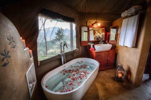 a large bathroom with a tub and a sink at Madulkelle Tea and Eco Lodge in Kandy