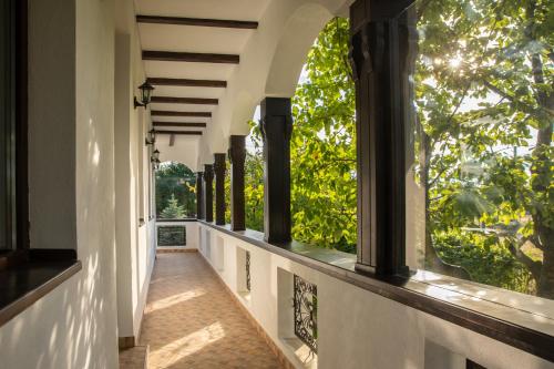 an empty corridor of a house with large windows at Conacul La Ciresi in Vălenii de Munte