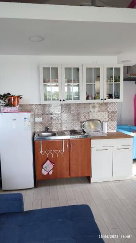 a kitchen with a sink and a refrigerator at Kucica Milica in Ulcinj