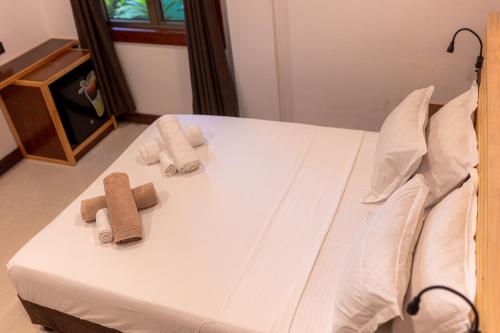 a bedroom with a bed with towels on it at Captal Island Villa in Mathiveri