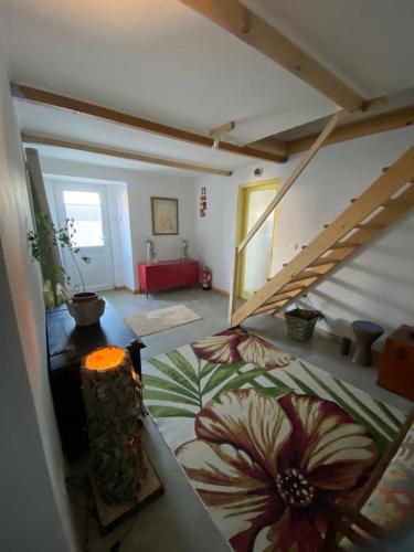 a living room with a staircase in a house at Casa das Mouriscas in Casalão