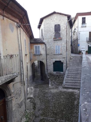 an alley in an old town with stone buildings at Villino Sabina in Civitella del Tronto