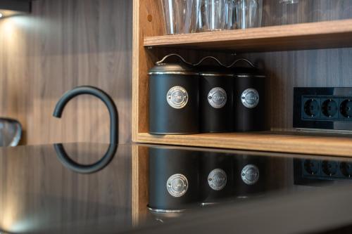 a row of clocks on a shelf in a kitchen at Apartman Riva in Vrnjačka Banja