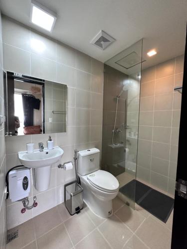 a bathroom with a toilet and a sink and a shower at THE PALLADIUM- Serene in Iloilo City
