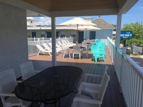 a patio with a table and chairs and an umbrella at White Marlin Inn in Ocean City