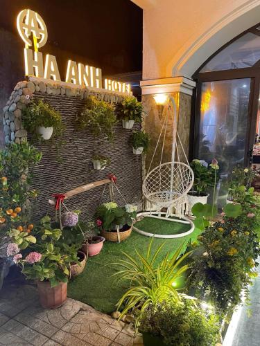 a garden with plants and a sign on a building at HÀ ANH hotel in Phường Sáu