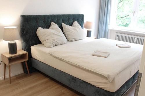 a bedroom with a large bed with white pillows at Cozy, Quiet Munich City Apartment in Munich