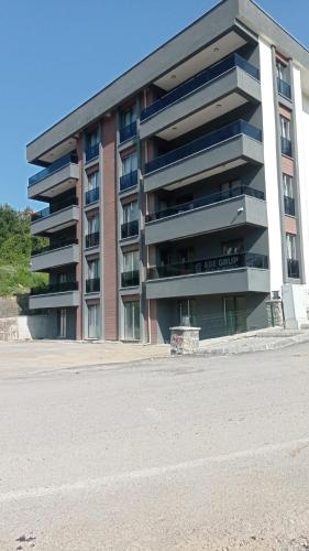 an apartment building with a parking lot in front of it at EGE SUİT OTEL in Amasra