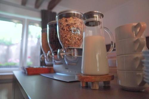 a blender with a container of milk on a counter at Hotel Frohnhauser Hof in Essen