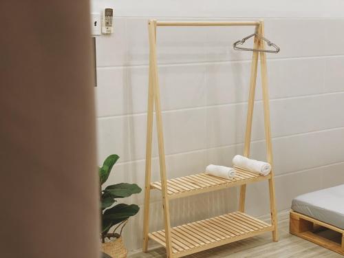 a bamboo towel rack in a bathroom with towels on it at B Home in Can Tho