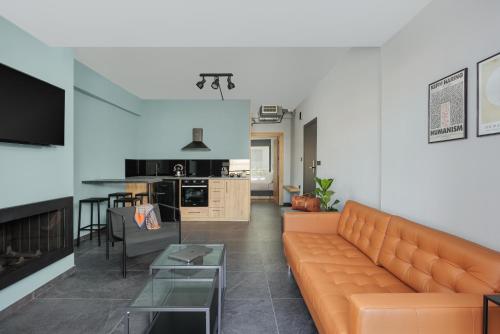 un soggiorno con divano e tavolo di THE URBANIST •inner city residences• a Ioannina