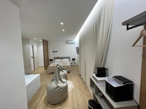 a white room with a room with a bed and a sink at Luxury - 5 Stars - Suite with a jacuzzi 70's rooms in Trapani