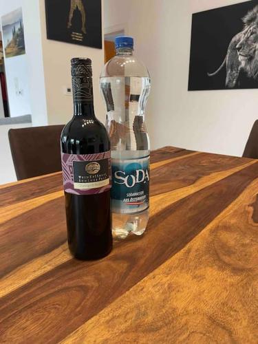 a bottle of wine sitting on a wooden table at Moderne Wohnung mit Stil in Grossgerungs