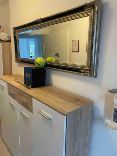 a mirror on the wall above a dresser in a room at Moderne Wohnung mit Stil in Grossgerungs