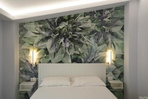 a bedroom with a floral wall mural above a bed at Harmony Tropea Rooms & Suites in Tropea