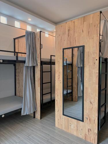 a room with two bunk beds and a mirror at B Home in Can Tho