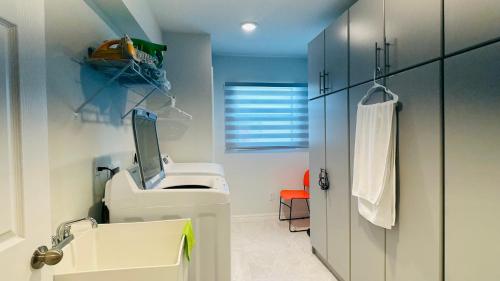 ein Badezimmer mit einem weißen Waschbecken und einem Spiegel in der Unterkunft The Salt Life Get Away - Cape Coral, Florida in Cape Coral