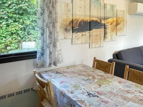 a dining room table with a view of a lion painting at 4 person holiday home in Beddingestrand-By Traum in Beddinge Strand