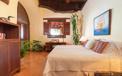 a bedroom with a large bed in a room at Sunny Vacation Villa No 64 in San Rafael del Yuma