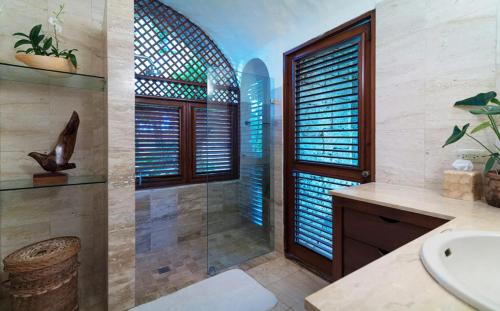 a bathroom with a shower and a sink at Sunny Vacation Villa No 64 in San Rafael del Yuma