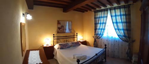 a bedroom with a bed and a window at Agriturismo Corte degli Angeli in Marina di Grosseto