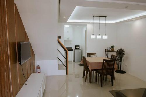 a kitchen and dining room with a table and chairs at Joanna's Place in Naga