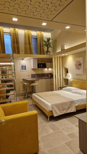 a bedroom with a large bed and a table at Iris Apartments in Monopoli