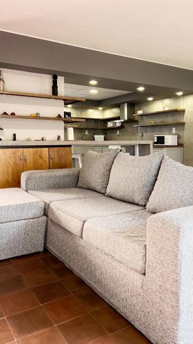 a large couch sitting in a living room at Dúplex Mendoza con cochera techada in Mendoza