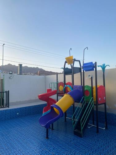 a playground with a slide on a roof at ليلتنا in Hail