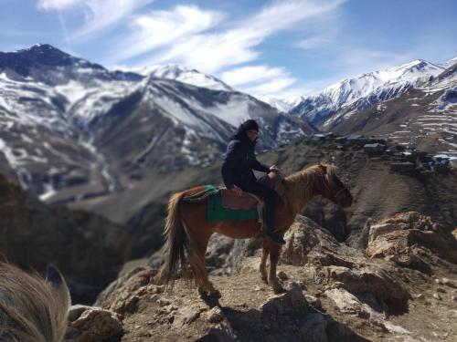 a person riding a horse on top of a mountain at Xinaliq Qonaq Evi in Xınalıq