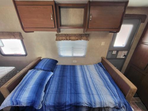 a bed in the back of a tiny house at Moceanset Getaways-Beautiful Ocean, Mountain & Sunset Views in Dingwall
