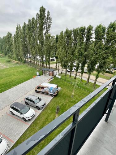 a balcony with a view of a parking lot with cars at Aqua Relax apartman in Dunajská Streda