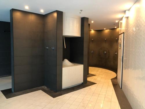 a bathroom with a shower with a toilet in it at Hanza Tower - SCANDIA Apartment, 16 Floor, Sunset View in Szczecin