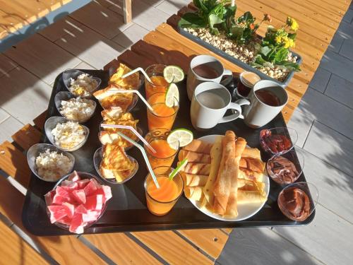 a tray of breakfast foods on a table at aux 4 saisons maison l'opaline in Le Tampon