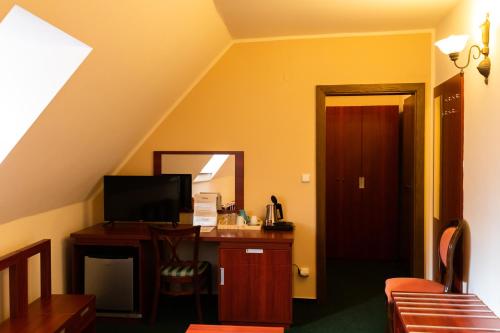 a room with a desk and a mirror and a staircase at Vivaldi Apartments in Mikulov