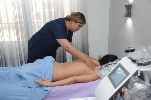 a woman in a spa salon getting ahaps at IN LUX Apartment Skopje 