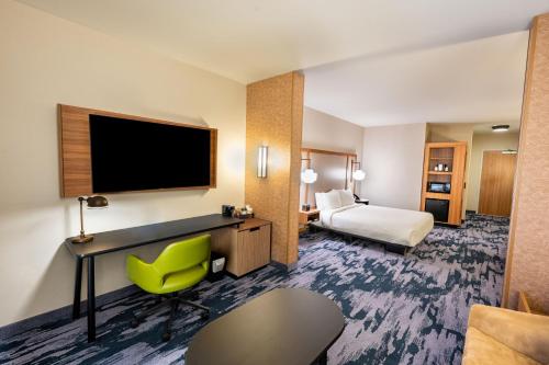 a hotel room with a bed and a flat screen tv at Fairfield by Marriott Inn & Suites Rome in Rome