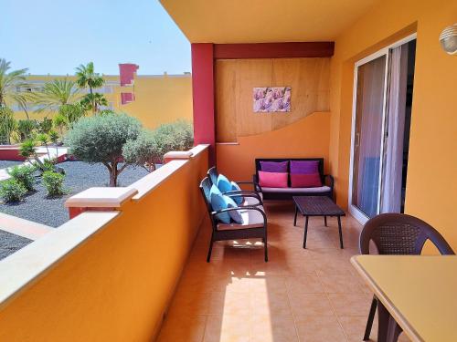 a balcony with chairs and a couch on it at Casa Mar y Dunas in Parque Holandes