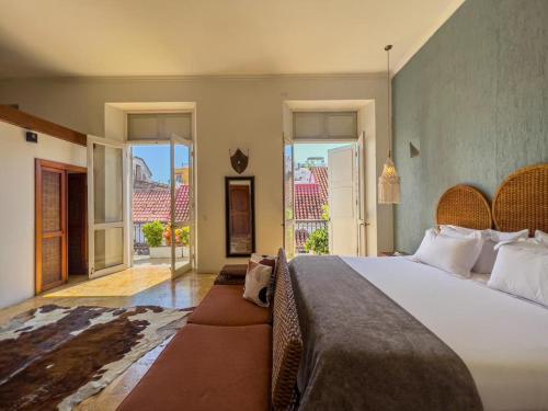 a bedroom with a large bed with a large window at San Pedro Claver Premiun - Private JACUZZI in Cartagena de Indias