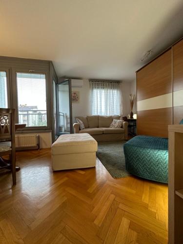 ein großes Wohnzimmer mit einem Sofa und einem Bett in der Unterkunft Lanište - Prelijep stan, balkon, wifi + besplatan parking in Zagreb