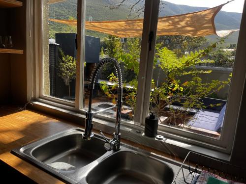 a sink in a kitchen with a window at Seven on Flora- Hot Tub, Modern with amazing outside area in Hermanus